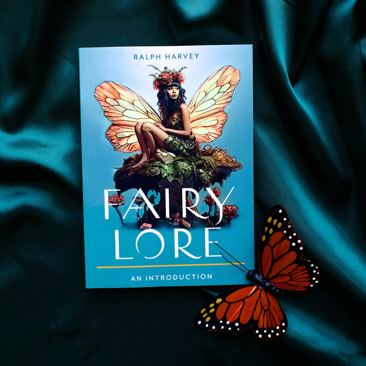 Fairy Lore book with illustrated fairy on cover and butterfly prop on teal fabric background