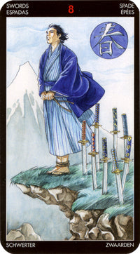 Tarot card Eight of Swords, featuring a robed figure bound by swords on a cliff, with mountain backdrop.