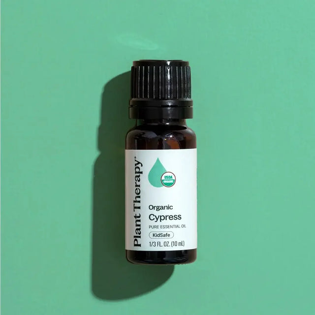 Plant Therapy organic cypress essential oil bottle on green background
