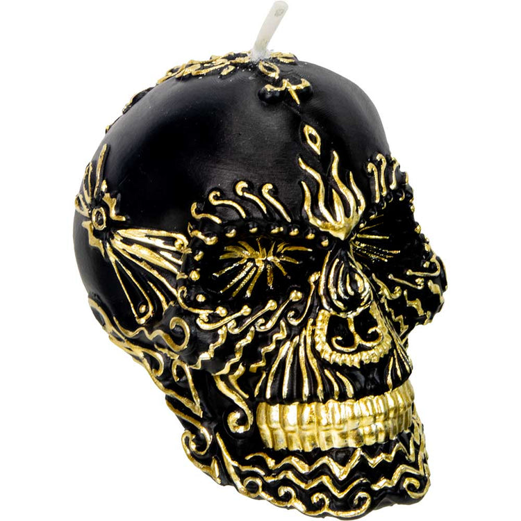 Black skull candle with gold ornate designs, metaphysical decor, gothic aesthetic