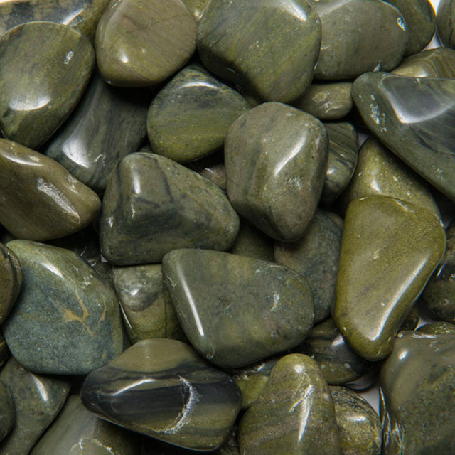 Polished green jasper tumbled stones close-up, metaphysical healing crystals