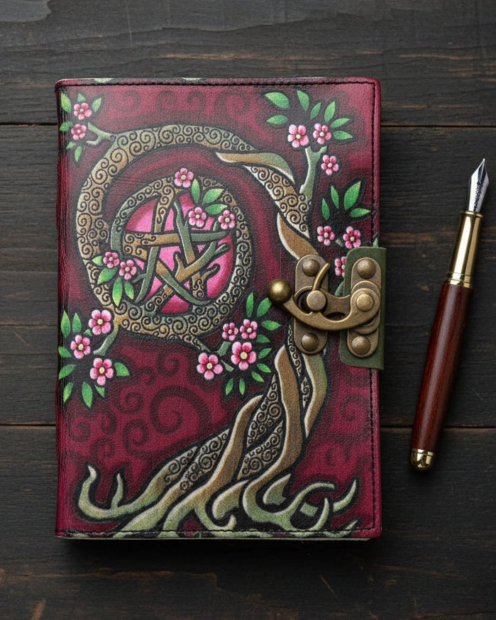 Pentacle tree journal with pink flowers, ornate brass lock, mystical art on burgundy cover