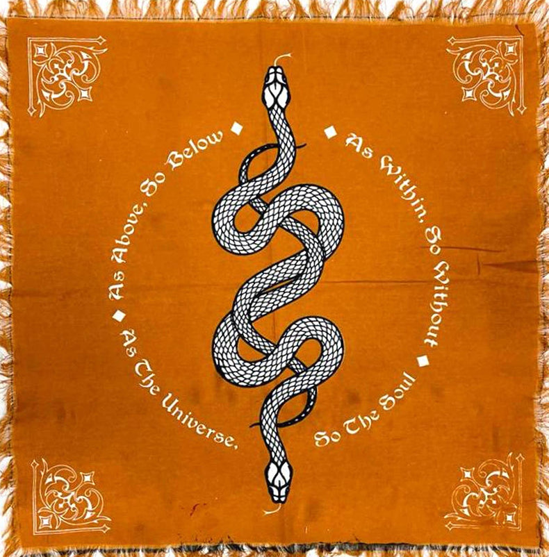Orange altar cloth with black snake, ornate corners, and metaphysical affirmation text