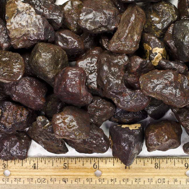 Raw shungite stones with natural texture, shown with ruler for size reference, ideal for metaphysical healing.