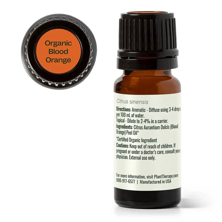 Amber bottle of organic blood orange essential oil with labeled cap and ingredient list visible
