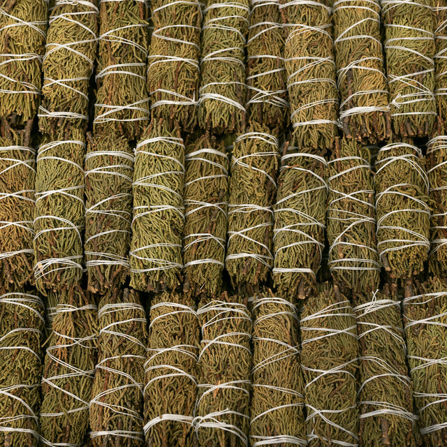 Dried cedar smudge bundles tied with white string for spiritual cleansing and meditation rituals