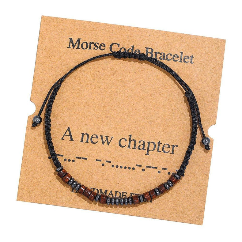 Handmade Morse code bracelet with black and brown beads on card that reads 'A new chapter'.