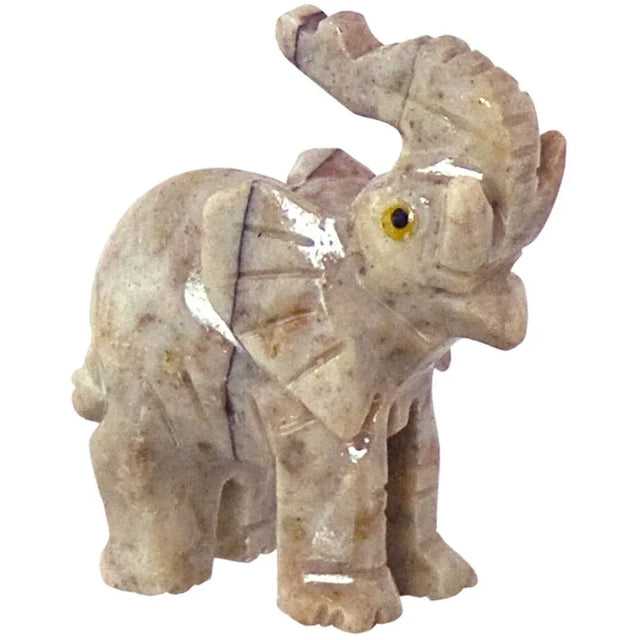 Polished crystal elephant figurine with trunk raised, used for metaphysical decor or healing