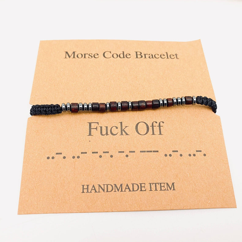 Handmade Morse code bracelet on card with beaded design and black cord