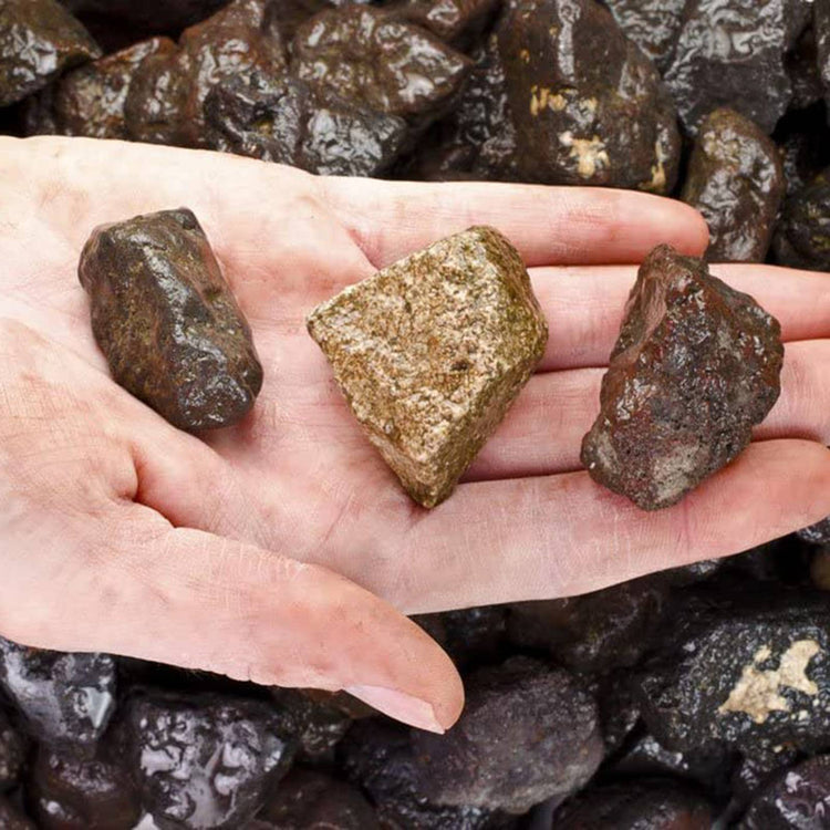 Hand holding raw healing crystals, natural stones for spiritual practice and metaphysical use
