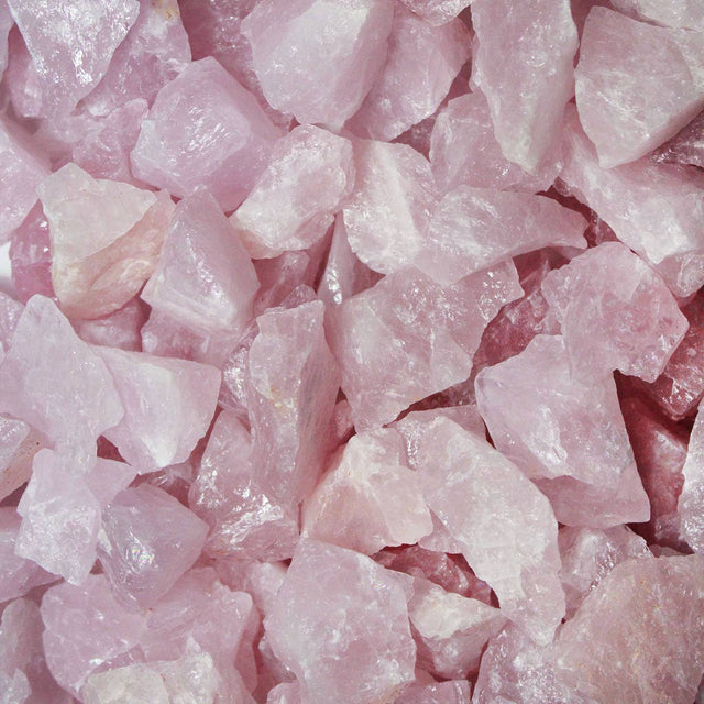 Raw rose quartz crystals with pink hues and rough natural texture