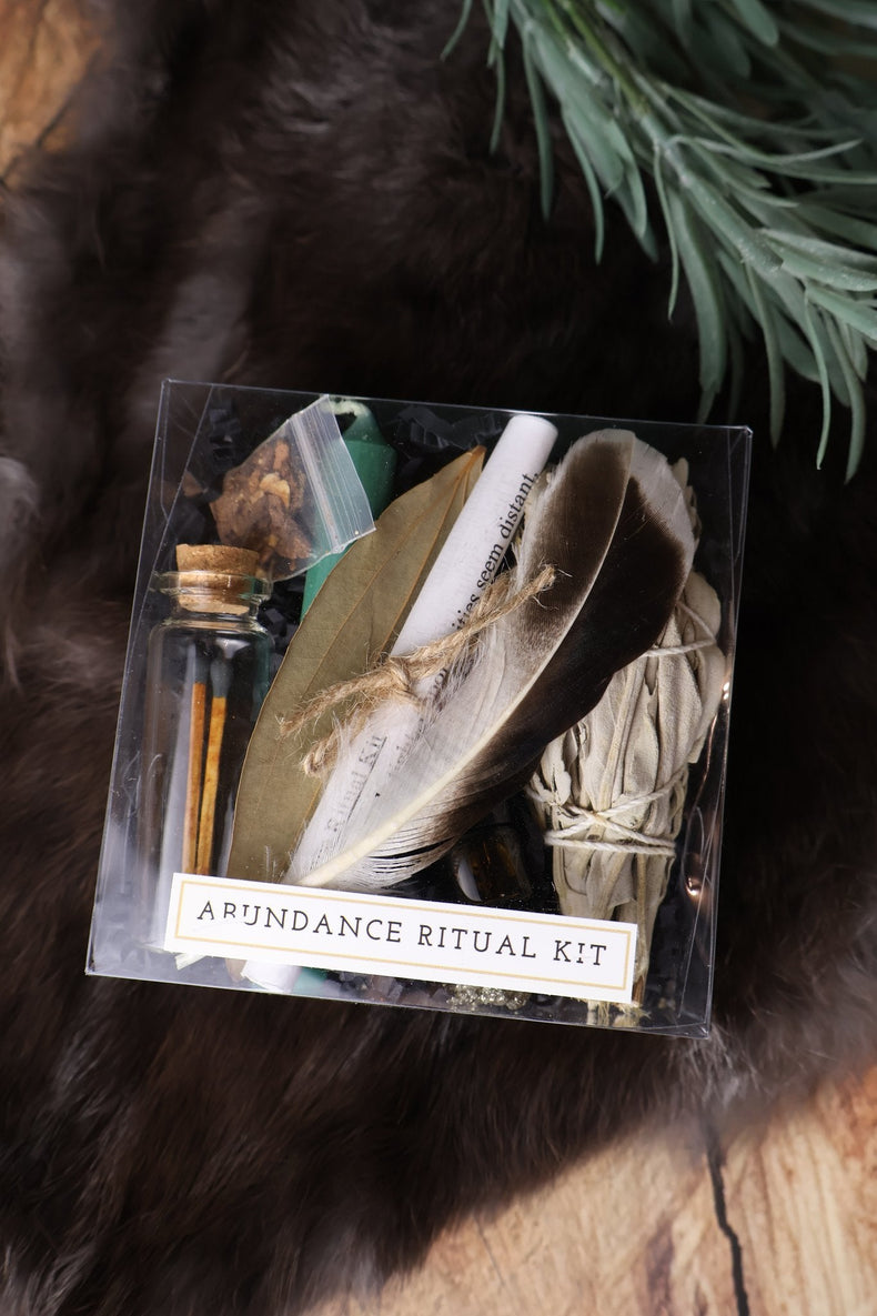 Abundance ritual kit with feather, sage and herbs