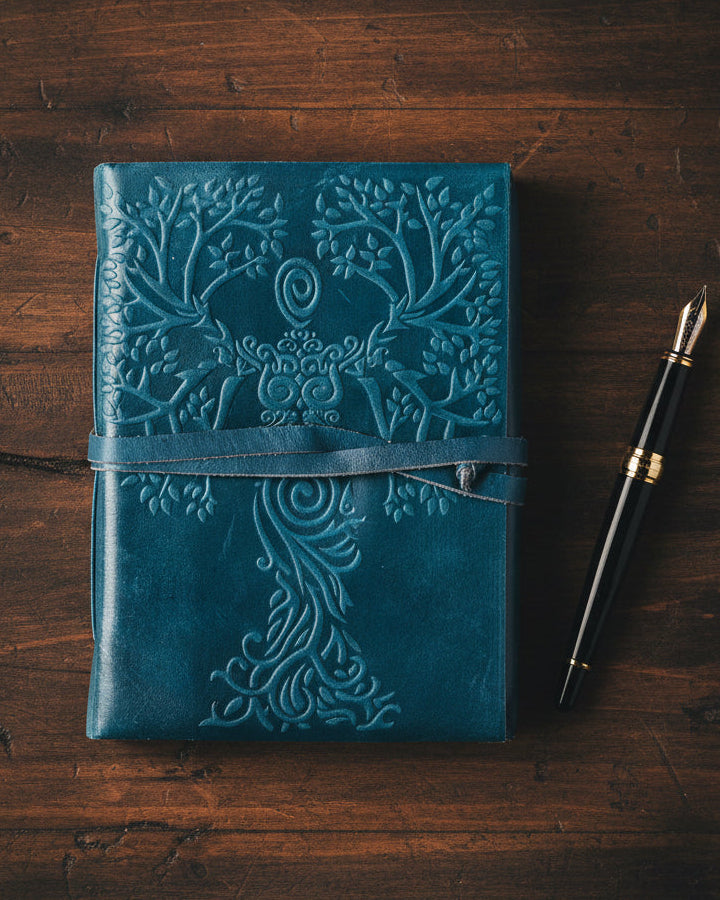 Teal leather journal with embossed goddess and tree design, metaphysical stationery