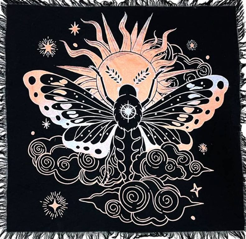 Decorative throw blanket with celestial design featuring a butterfly and sun on a black background.