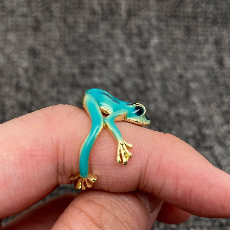 Turquoise frog-shaped ring with gold accents on hand, unique animal jewelry