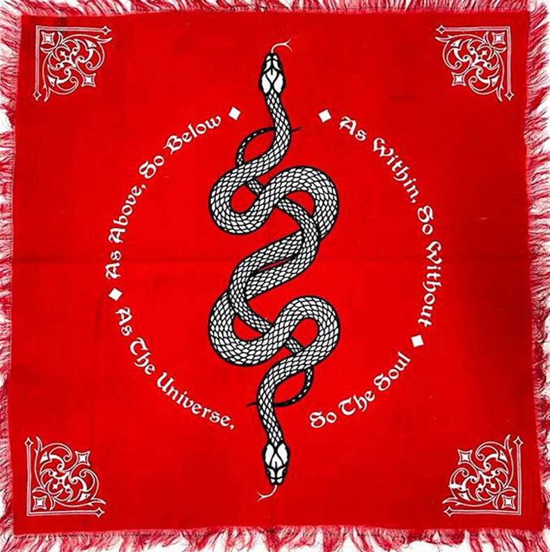 Red altar cloth with black and white snake illustration, mystical text, and ornate corners.