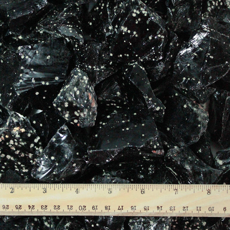 Snowflake obsidian crystal chunks with a ruler for scale