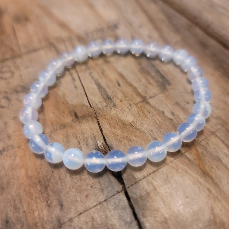 Opalite bead bracelet on rustic wooden surface