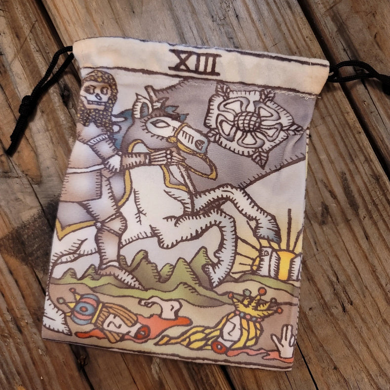 Tarot deck pouch with Death card illustration, Roman numeral XIII, on rustic wood background.