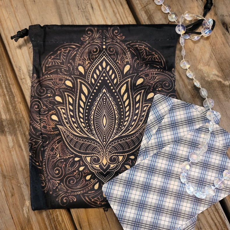 Tarot deck pouch with mandala design, tarot cards, and crystal beads on wood
