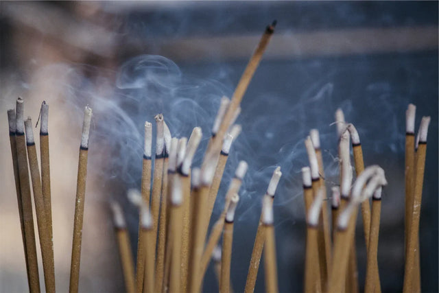 Burning incense sticks with rising smoke, meditation and spiritual ritual atmosphere