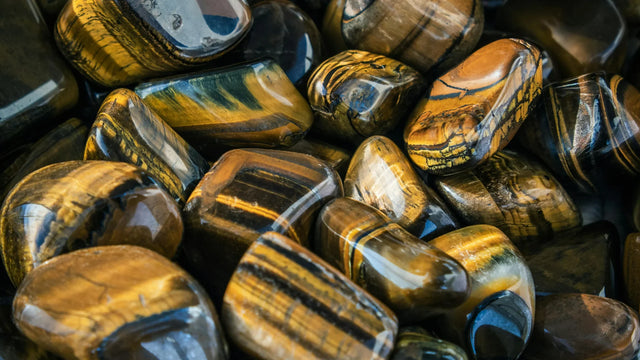 Polished tiger's eye tumbled stones with golden brown bands for crystal healing and energy work
