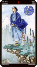 Tarot card Eight of Swords, featuring a robed figure bound by swords on a cliff, with mountain backdrop.