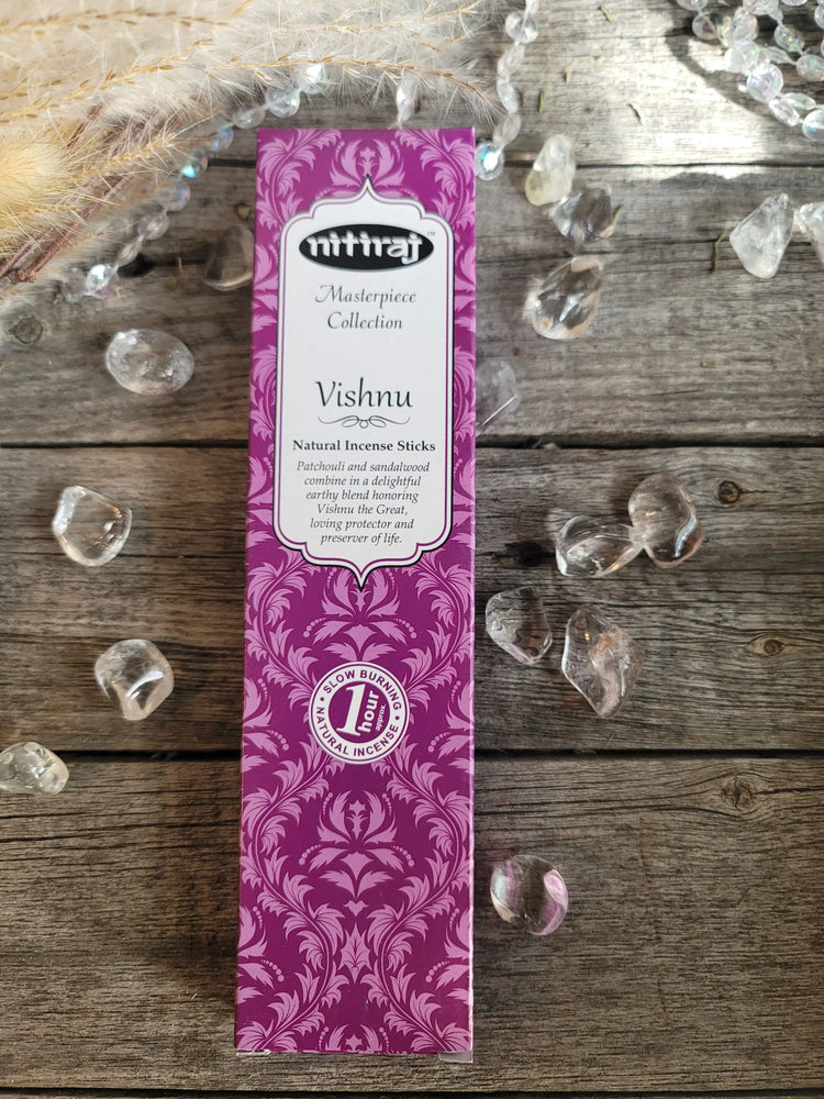 Purple Nitiraj Vishnu incense box on wood surrounded by clear healing crystals