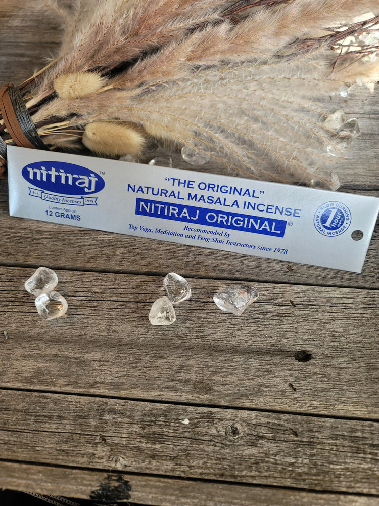 Nitiraj natural masala incense with clear quartz crystals and dried pampas grass on wood table