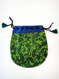 Green paisley drawstring tarot bag with blue patterned trim on white background