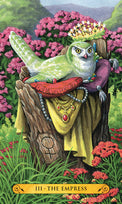 Tarot card III The Empress featuring a crowned green owl on a throne amid flowers, symbolizing abundance and nature magic.