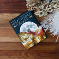 Moon Temple Oracle deck with lunar artwork, dried flowers, and white fern on wood