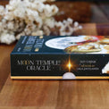 Moon Temple Oracle deck by Suzy Cherub, spiritual guidance cards with celestial artwork on wooden table