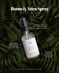 Abundance aura and room spray bottle with natural ingredients on green fern background