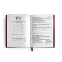 Open tarot journal with card spread guide and handwritten tarot reading notes, metaphysical theme