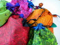 Colorful patterned drawstring bags for tarot cards or crystals on white background
