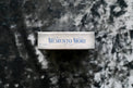 Memento Mori tarot deck box on a dark textured background