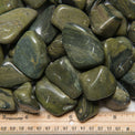 Tumbled green jasper stones with ruler for size, healing crystals for metaphysical use