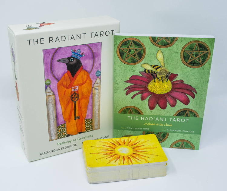 The Radiant Tarot deck with illustrated box, guidebook, and tarot cards featuring sun design.