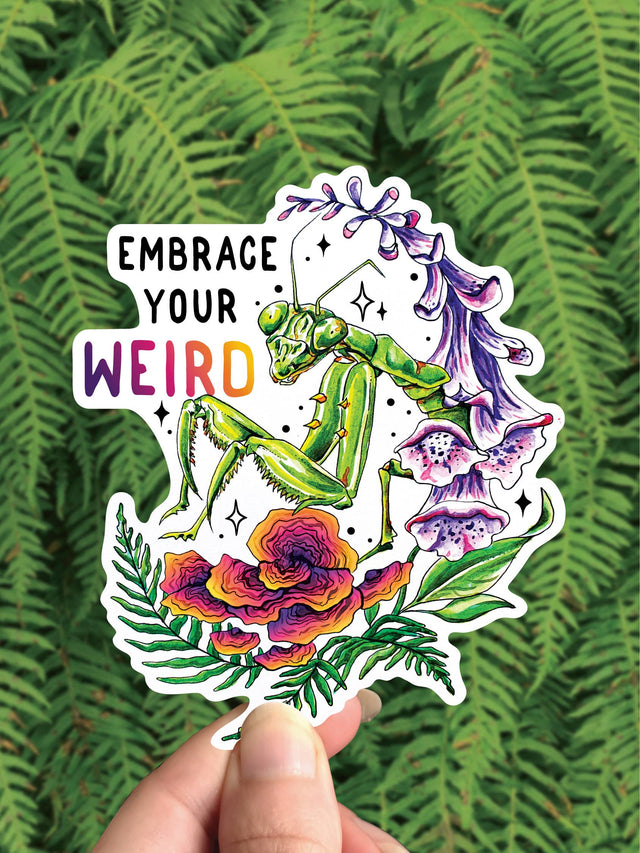 Embrace Your Weird vinyl sticker with a green praying mantis on a red shelf mushroom and purple foxglove