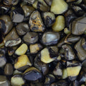 Polished tumbled septarian stones with brown, yellow, and black patterns close-up