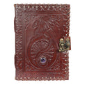 Embossed leather journal with dragon design, gemstone detail, and metal clasp for metaphysical use.