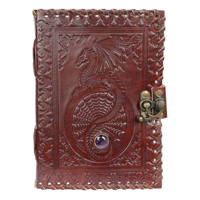 Embossed leather journal with dragon design, gemstone detail, and metal clasp for metaphysical use.