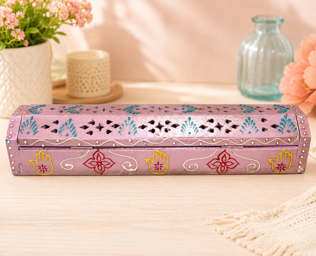 Hand-painted pink incense burner with Hamsa hands, floral motifs, and decorative cutouts for spiritual rituals