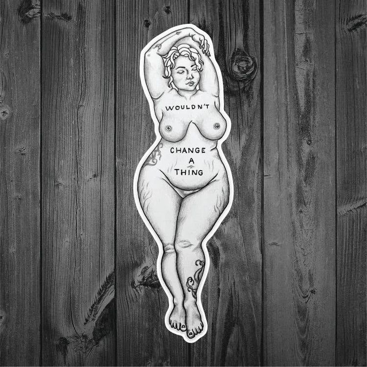 Wouldn't Change a Thing sticker shown on dark wood