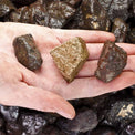 Hand holding raw healing crystals, natural stones for spiritual practice and metaphysical use