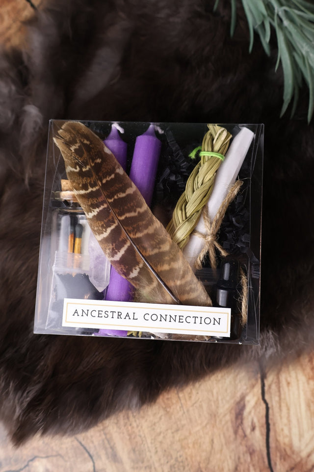 Ancestral Connection ritual kit with purple candles, sweetgrass and feather
