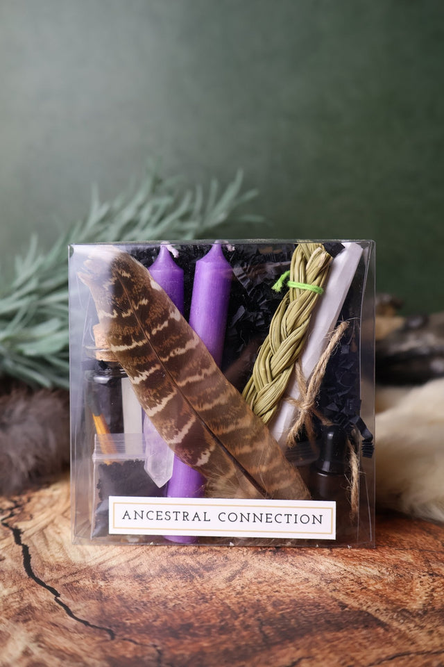 Ancestral Connection ritual kit with purple candles, sweetgrass and feather