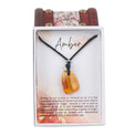 Amber crystal pendant necklace on black cord in gift box with descriptive card