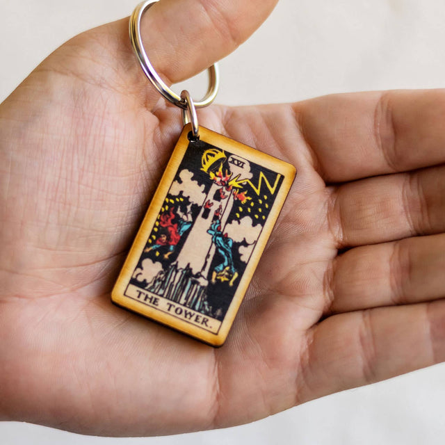 Wooden keychain featuring The Tower tarot card, ideal for spiritual and metaphysical enthusiasts.